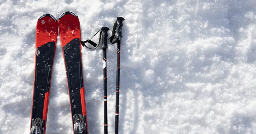 Mountain skis on bright alpine snow. Winter holidays.