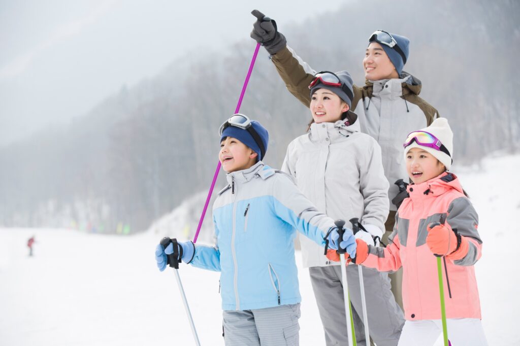 Young family skiing in ski resort
